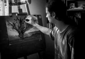 grayscale photography of man painting a tree