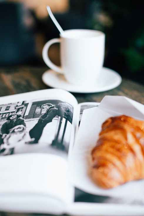 white ceramic mug on wooden table